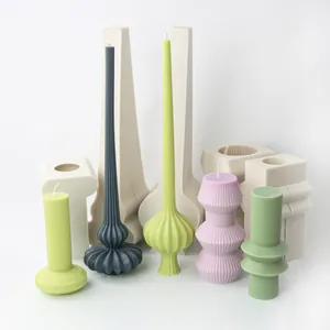 Nordic style ribbed pillar and pumpkin base silicone candle molds with finished wax candles.