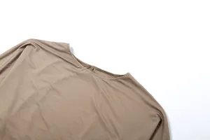 Detailed close-up of the round neckline and fabric on a brown long-sleeved bodysuit
