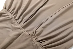 Close-up macro view of the ruched fabric detail and fine stitching on a sexy solid jumpsuit