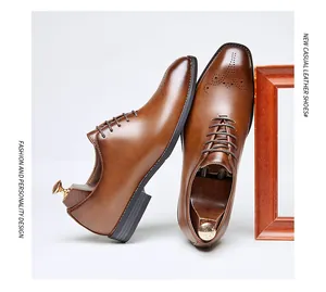 A detailed view of men's brown leather brogue oxford shoes featuring elegant carvings