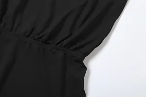 Detailed macro view showing the elastic ruched waist and fine stitching of black jumpsuit