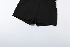 Close-up detail of the hem and fabric texture on a black solid color bodysuit shorts.