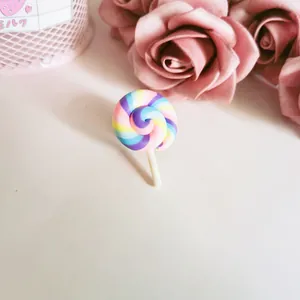 Detailed macro view of a cute colorful rainbow polymer clay lollipop brooch for clothing