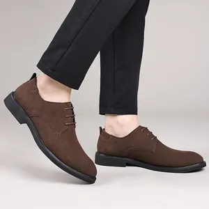 Detailed side view of men's brown textured suede derby shoes featuring black rubber soles