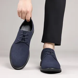 Close-up of navy blue suede men's derby shoes with lace-up detail and black sole