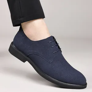 Detail shot of a navy blue suede Derby shoe featuring a stylish pointed toe design