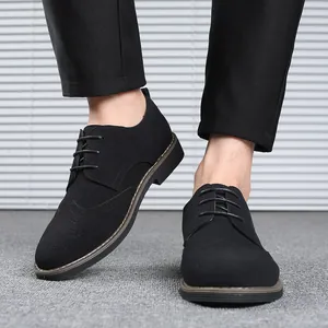 Stylish black suede brogue shoes for men with lace-up design and classic wingtip details