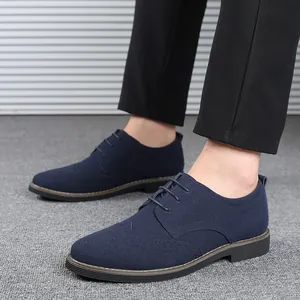 Fashionable men's navy blue suede brogue shoes with a classic lace-up wingtip design