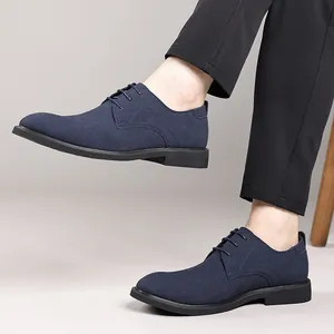 Side view detail of navy blue suede Derby shoes with classic lacing and black sole.