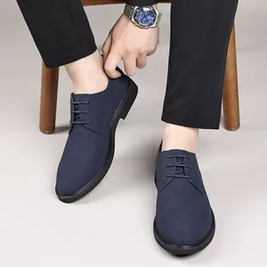 Close-up view of stylish navy blue suede derby shoes worn with black casual trousers