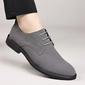 Detail view of gray suede-like lace-up dress shoe with premium stitching.