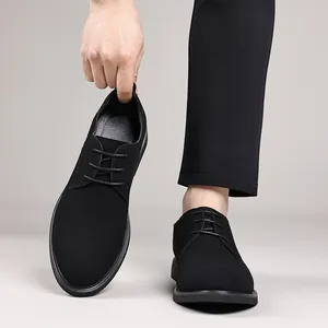 Detail view of stylish black suede derby shoes featuring elegant lace-up design for men