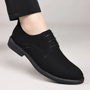 Close-up detail of black suede British style lace-up dress shoes worn by a male model