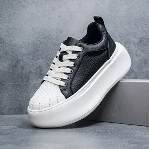 Side view of a premium black leather shell-toe sneaker with chunky white platform sole