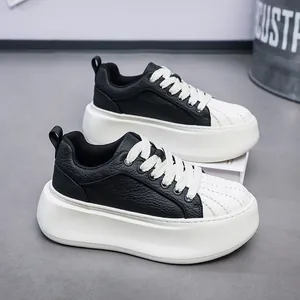 Detail view of men's platform shell-toe sneakers in black and white leather finish