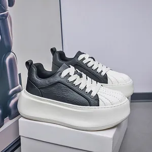Detailed shot of men's trendy black and white platform sneakers with shell-toe design.