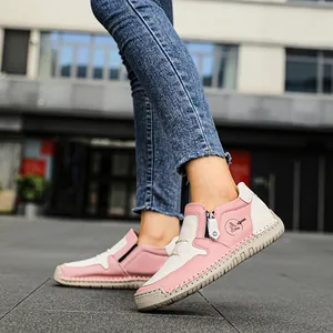 Primo piano di stivaletti casual in pelle rosa e bianchi da donna in esterni reali