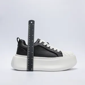 Detail shot of men's shell-toe platform sneaker showing 7cm heel height measurement