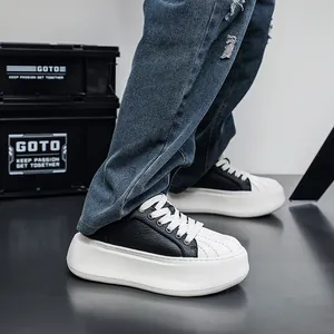 Close-up of trendy men's platform shell-toe sneakers with black and white contrast