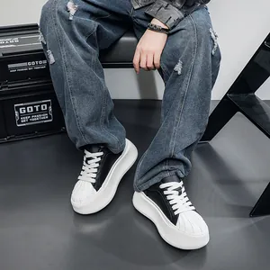 Detail view of stylish men's platform shell toe sneakers with black and white leather finish