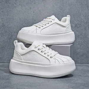 Detailed side view of white platform sneakers with shell toe and chunky sole design.