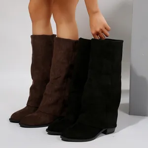 Side view of women's slouchy suede knee-high boots in black and brown