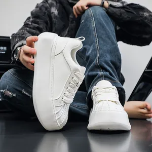 Close-up of white platform sneakers with shell-toe detail and thick sole