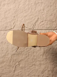Detailed view of a brown boot sole featuring anti-slip texture and size 37 mark.