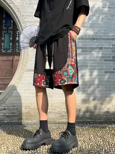 Detail of men's ethnic style shorts featuring vibrant patterns and tassel drawstrings