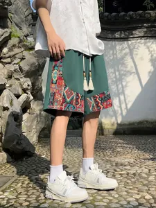 Detailed view of men's ethnic shorts with colorful patchwork and tassel drawstrings