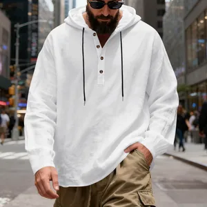 Detail view of a white breathable linen hooded Henley shirt for men on a street