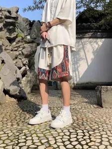 Men's ethnic style loose linen shorts with colorful patterned panels for summer casual wear