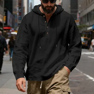 Close-up of a black breathable linen hooded Henley shirt for men in a stylish urban setting