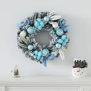 Blue and white flocked Christmas wreath with bows and ornaments for door decor