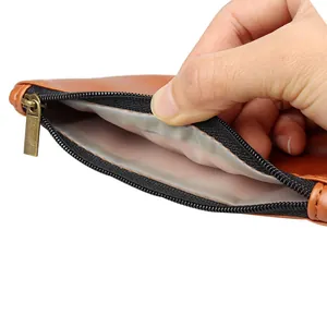 Close-up detail of the brown PU leather tobacco pouch showing the internal rubber lining