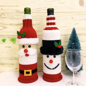 Detailed view of Santa and Snowman knitted wine bottle covers for Christmas decoration.