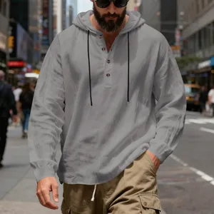 Detail view of the breathable linen fabric and Henley button neck on a men's grey hoodie