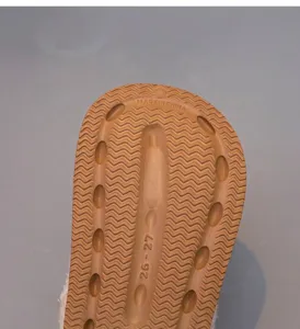 Close-up of non-slip brown sole for children's winter slippers with grip texture
