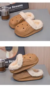 Detailed view of khaki children's winter slippers with thick plush white lining.