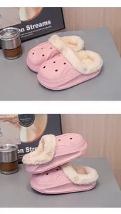Close-up of pink children's winter clogs with warm plush lining and thick EVA sole