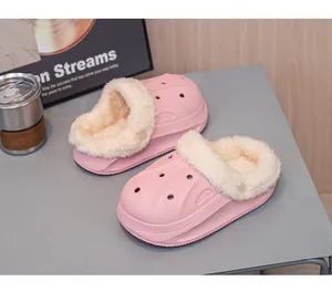 Close-up detail of pink children's winter clogs with warm white faux-fur lining