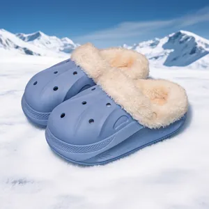 Cozy blue children's winter clogs with warm fur lining on a snowy mountain background.