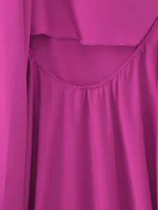 Detailed view of magenta satin halter dress showing smooth fabric texture and pleats.