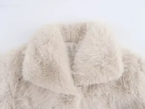 Detail of beige faux fur coat featuring a plush lapel collar and soft texture