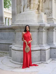 Elegant red halter neck silk satin dress for women in a classic outdoor setting
