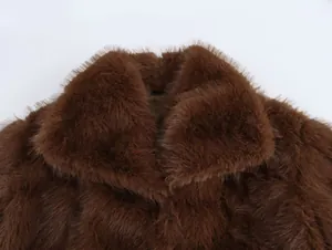 Detailed close-up showing the soft texture and lapel design of a brown faux fur jacket