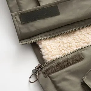 Dettaglio macro della cerniera del parka verde e della calda fodera in pile sherpa