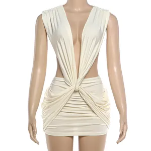 Detail view of cream deep V-neck sleeveless dress with elegant twist waist and pleated skirt