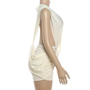 Side profile of a sexy cream sleeveless ruched mini dress featuring a deep V-neckline