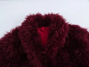 Macro view of luxurious burgundy faux fur texture and lapel design on winter coat